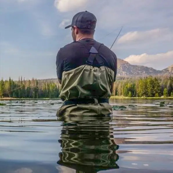 Person flying fishing with mountain in background